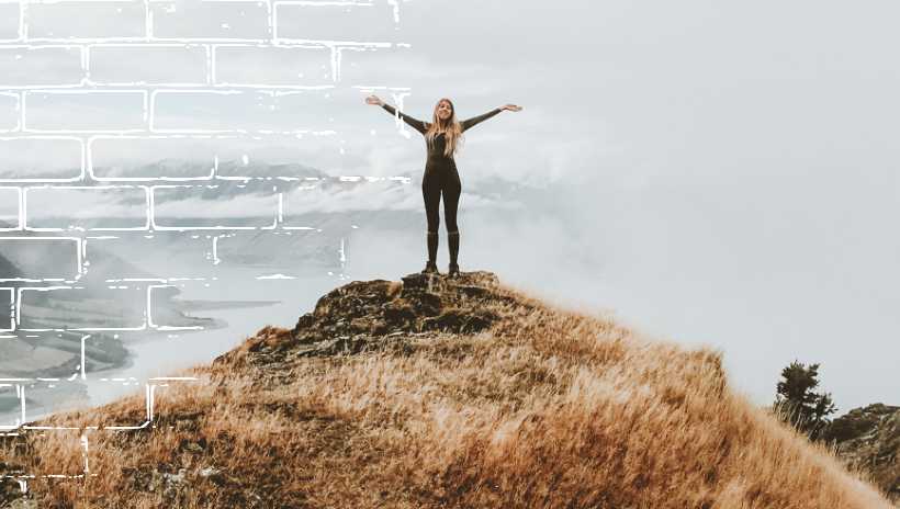 mujer en la cima de una montaña